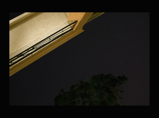 night, edge of generic southern california boulding, tree and night sky with stars