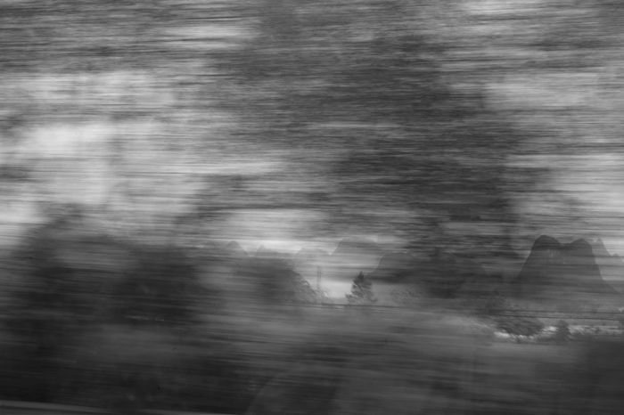 mountains loom in the distance as foreground rushes by